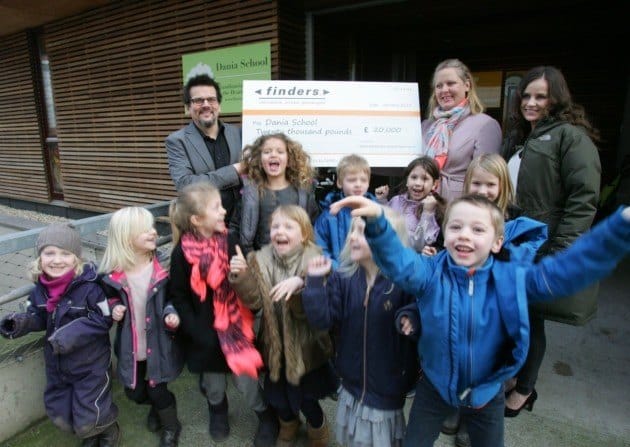 Finders' Daniel Curran presents the cheque to Dania School